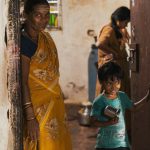 IoT Home - Woman in Yellow Dress Standing Beside Man in Black Shirt