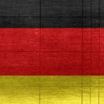 AI Global - Grungy background designed as flag of Germany on shabby wooden board with measure scale