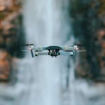 Flying Drone - selective focus photography of quadcopter drone