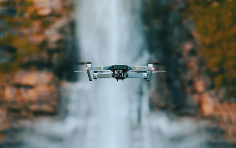 Flying Drone - selective focus photography of quadcopter drone