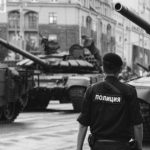 Cybersecurity Risk - Policeman walking near Tanks