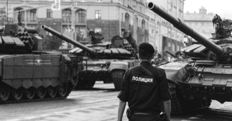 Cybersecurity Risk - Policeman walking near Tanks