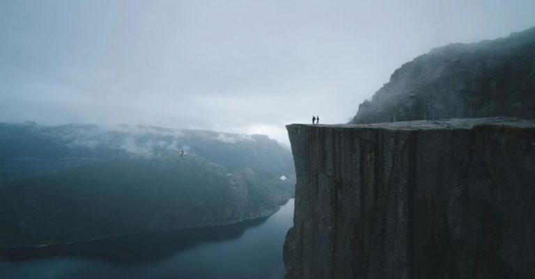 Edge Computing - Two People On Mountain Cliff