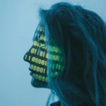 AI Cybersecurity - A Woman with Number Code on Her Face while Looking Afar