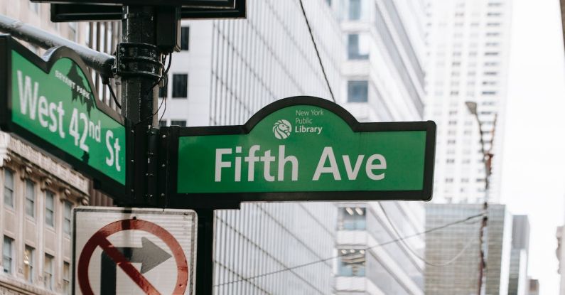 AI Public Safety - Metal post with direction indicator on avenue with high skyscrapers in New York