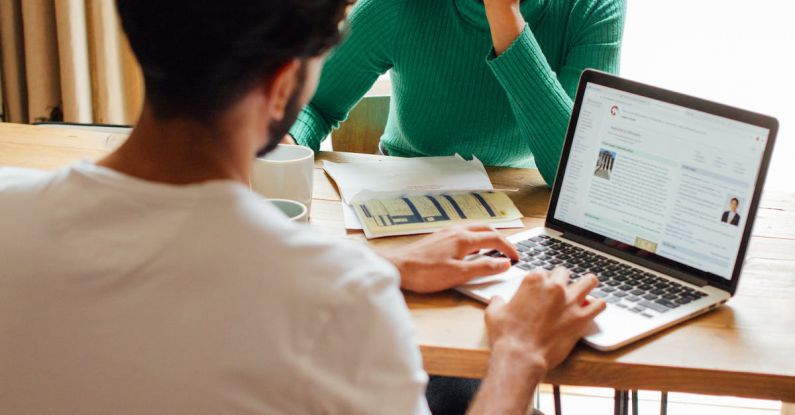 Remote Work - Woman In Green Long Sleeve Shirt Sitting In Front Of A Man