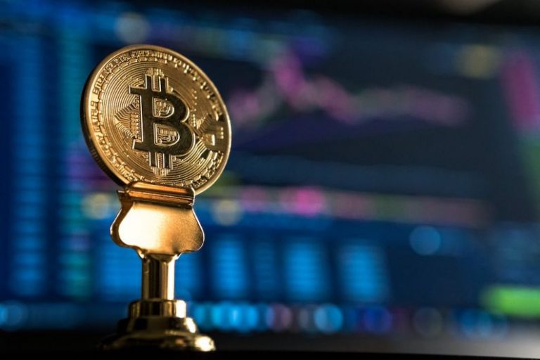 Digital Currency - selective focus photo of Bitcoin near monitor