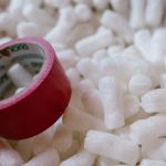 Biodegradable Materials - Red Duct Tape and Packing Peanuts Inside A Carton Box