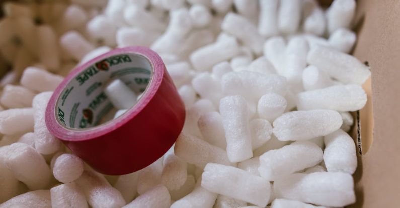 Biodegradable Materials - Red Duct Tape and Packing Peanuts Inside A Carton Box