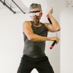 VR Art - Man using Nunchaku while wearing Virtual Reality Glasses