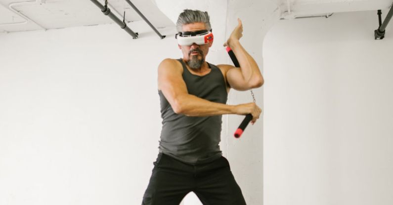 VR Art - Man using Nunchaku while wearing Virtual Reality Glasses