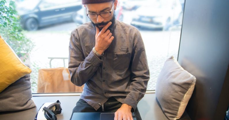 VR Business - Man Working on Laptop in Cafeteria