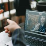 VR Language - Young lady learning sign language during online lesson with female tutor