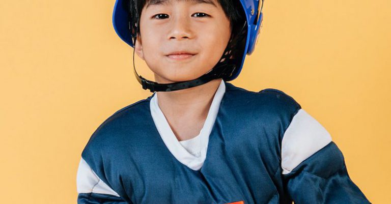 Skills Future - Satisfied ethnic child in American football player costume and helmet