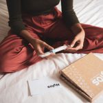 Biotech Food - woman in red dress holding white pen