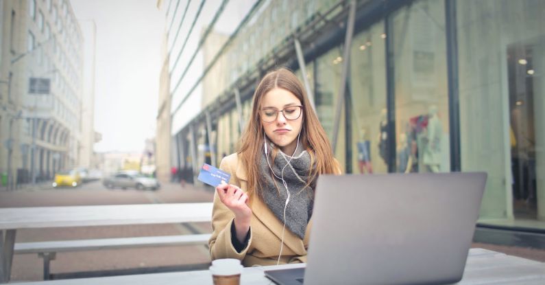 Accessible City - Woman in Brown Coat Holding a Bank Card