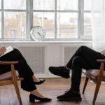 Gaming Mental Health - Person in Black Pants and Black Shoes Sitting on Brown Wooden Chair