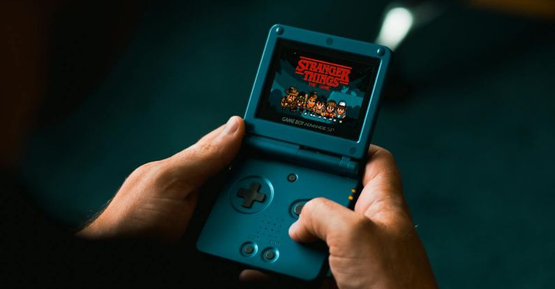 Retro Gaming - Person Playing With Handheld Game Console