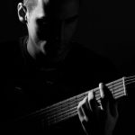 Games Pop Culture - Grayscale Photo of Man Playing Guitar