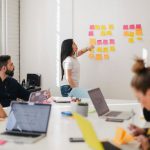 Future Workplace - woman placing sticky notes on wall