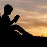 Lean In Book - silhouette of child sitting behind tree during sunset