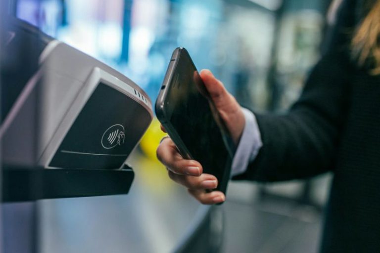 Mobile Payment - woman holding Android smartphone